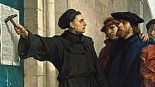 [1] Dass Luther die 95 Thesen an das Portal der Schlosskirche in Wittenberg am 31. Oktober 1517 geschlagen hat, ist wissenschaftlich nicht gesichert. Es wird trotzdem als Startpunkt der Reformation angesehen. (Bildausschnitt: Ferdinand Pauwels, Luthers Thesenanschlag, 1872)