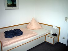 [1] Bett mit angebautem Nachttisch